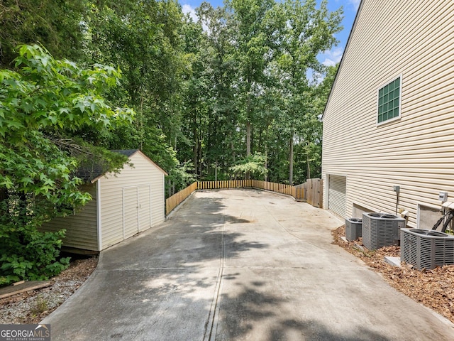 6439 Mossy Boulder Dr, Flowery Branch, GA 30542 - view of patio with a storage shed and concrete driveway