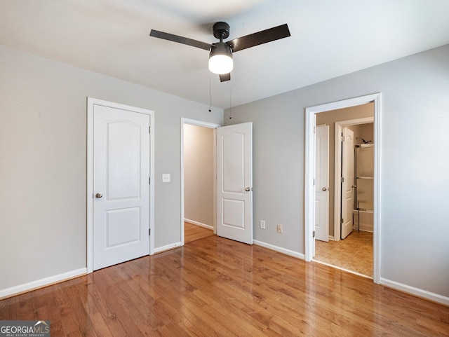 6439 Mossy Boulder Dr, Flowery Branch, GA 30542 - unfurnished bedroom featuring light wood finished floors, a ceiling fan, and ensuite bathroom