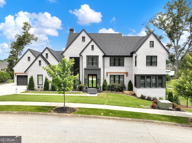 5832 Lula Bridge Ln, Braselton, GA 30517 - view of front of home with concrete driveway, a front lawn, a chimney, and brick siding