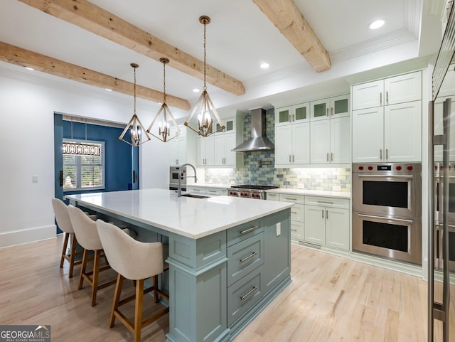 5832 Lula Bridge Ln, Braselton, GA 30517 - kitchen featuring wall chimney range hood, stainless steel double oven, a chandelier, light wood-style flooring, and beamed ceiling