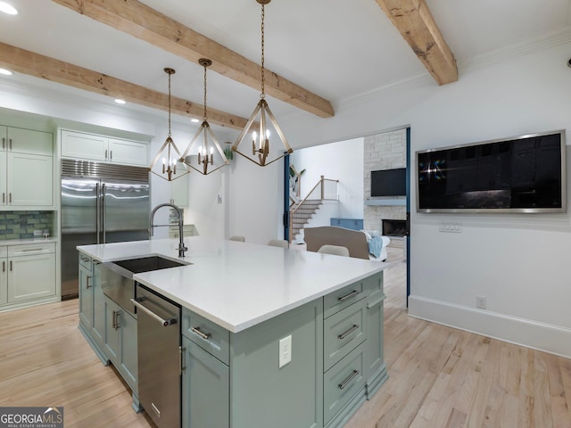 5832 Lula Bridge Ln, Braselton, GA 30517 - kitchen with stainless steel appliances, beam ceiling, light wood-style floors, a chandelier, and light countertops