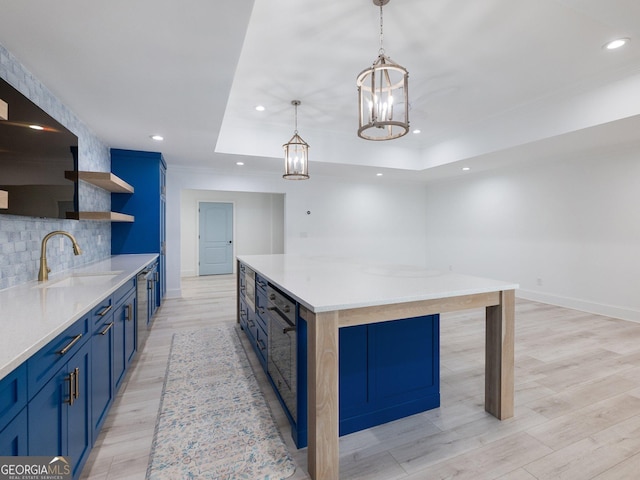 5832 Lula Bridge Ln, Braselton, GA 30517 - kitchen with blue cabinets, open shelves, tasteful backsplash, recessed lighting, and light wood-type flooring