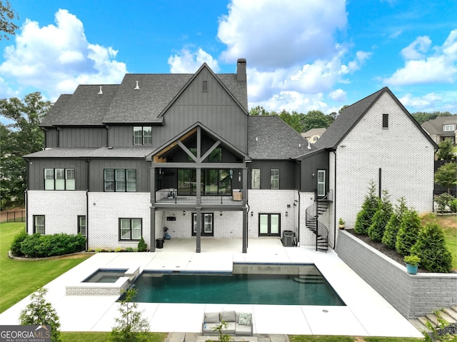 5832 Lula Bridge Ln, Braselton, GA 30517 - rear view of house featuring a balcony, board and batten siding, a patio area, stairway, and a chimney