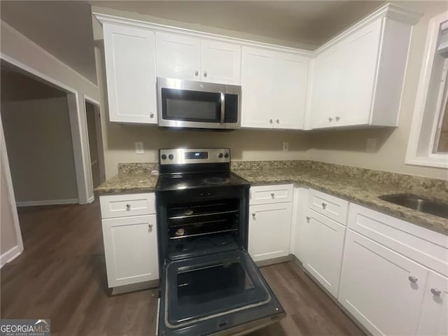 2785 Battle Forrest, Decatur, GA 30034 - kitchen featuring stainless steel microwave, dark wood-style flooring, white cabinets, and light stone counters