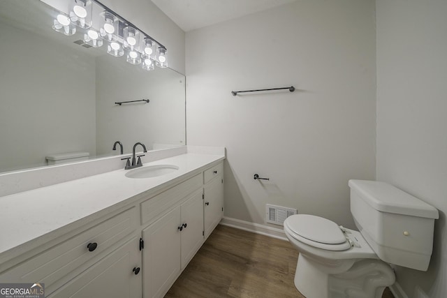 4732 Manly Ct, Stone Mountain, GA 30088 - bathroom with toilet, vanity, wood finished floors, and baseboards