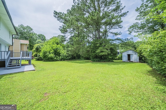 4732 Manly Ct, Stone Mountain, GA 30088 - view of green lawn with a wooden deck and view of wooded area