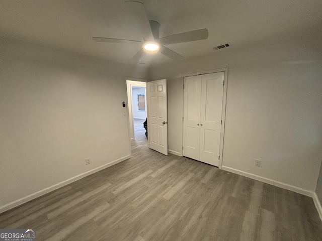 3685 Rice Mill Rd, Macon, GA 31206 - unfurnished bedroom with baseboards, wood finished floors, a closet, and ceiling fan
