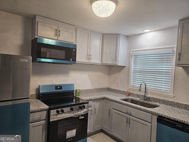 3685 Rice Mill Rd, Macon, GA 31206 - kitchen featuring stainless steel appliances, a sink, light stone countertops, gray cabinetry, and recessed lighting