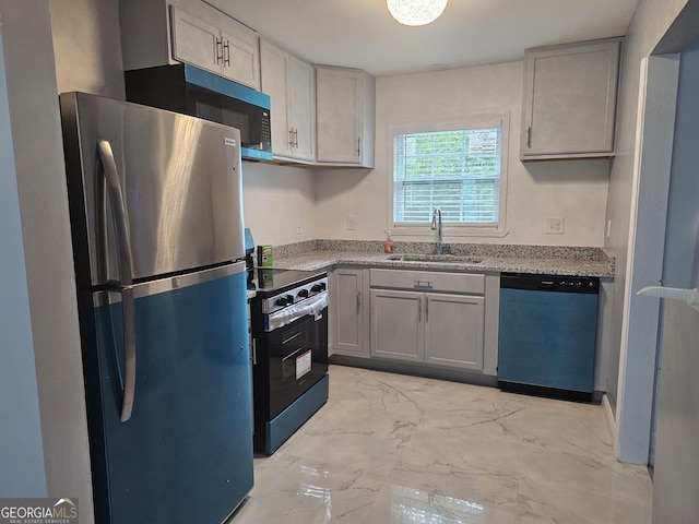 3685 Rice Mill Rd, Macon, GA 31206 - kitchen featuring appliances with stainless steel finishes, a sink, light marble finish floors, gray cabinets, and light stone counters