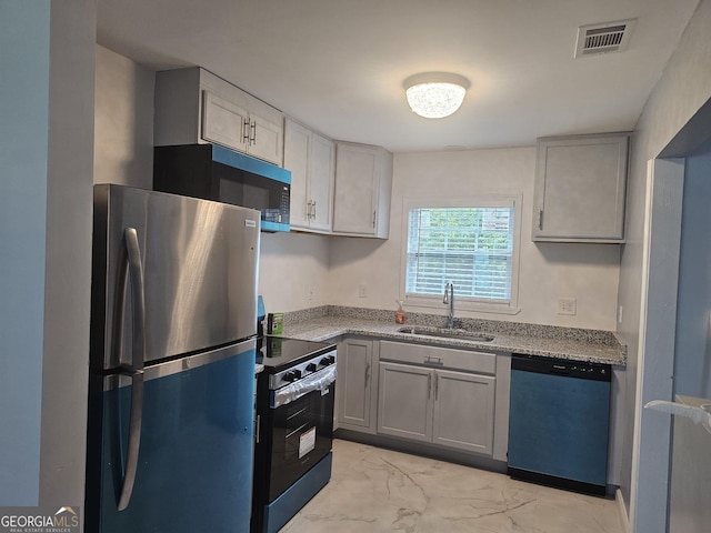 3685 Rice Mill Rd, Macon, GA 31206 - kitchen with stainless steel appliances, a sink, light marble finish floors, and gray cabinetry