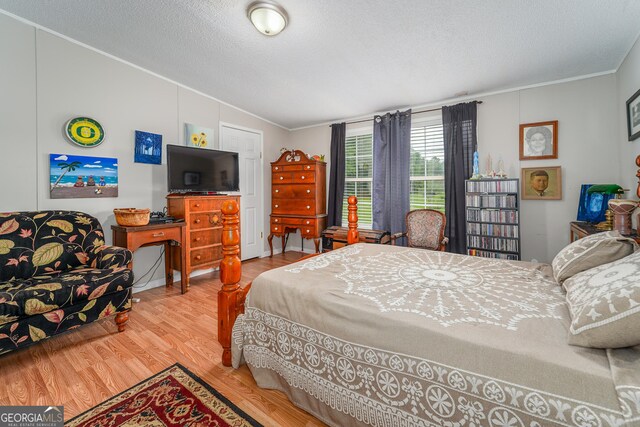 6162 Ayrin Brooke Ln, Blackshear, GA 31516 - bedroom featuring vaulted ceiling, ornamental molding, wood finished floors, and a textured ceiling