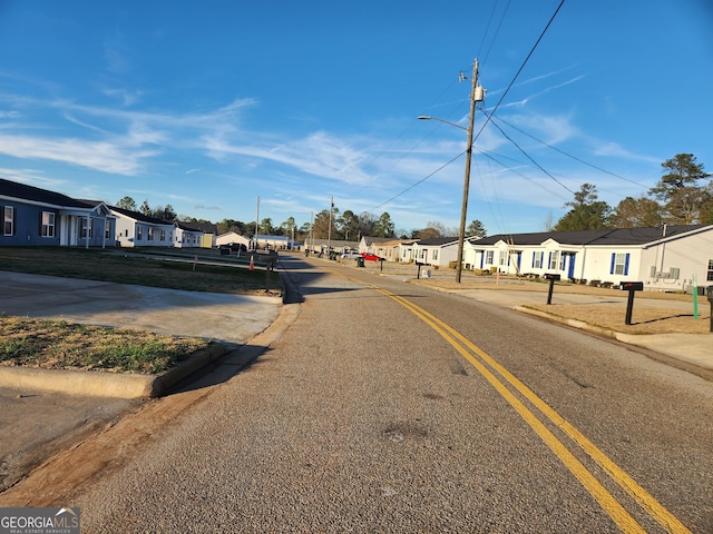 116 Ronald Pride Blvd, Fort Valley, GA 31030 - view of asphalt road with a residential view, street lights, and curbs