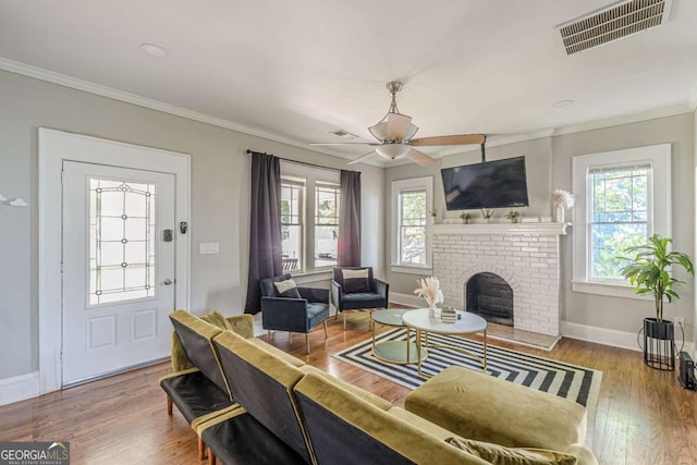 975 Dill Ave SW, Atlanta, GA 30310 - living area featuring healthy amount of natural light, a brick fireplace, ceiling fan, wood finished floors, and ornamental molding