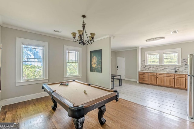 975 Dill Ave SW, Atlanta, GA 30310 - playroom featuring healthy amount of natural light, ornamental molding, a chandelier, pool table, and light wood-type flooring