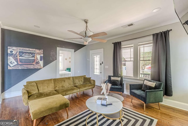 975 Dill Ave SW, Atlanta, GA 30310 - living room with crown molding, wood finished floors, a ceiling fan, and a wood stove