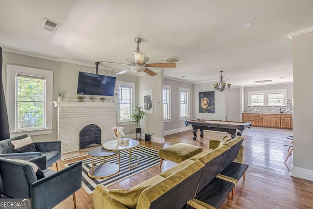 975 Dill Ave SW, Atlanta, GA 30310 - living area featuring billiards table, ornamental molding, a brick fireplace, wood finished floors, and a ceiling fan
