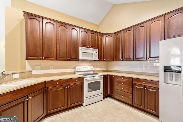 140 Rehobeth Way, Fayetteville, GA 30214 - kitchen with white appliances, light floors, light countertops, backsplash, and lofted ceiling
