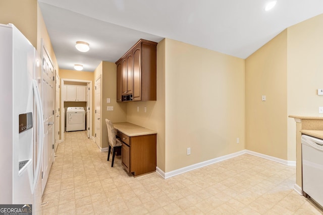 140 Rehobeth Way, Fayetteville, GA 30214 - kitchen featuring white appliances, washer / clothes dryer, light floors, light countertops, and brown cabinets
