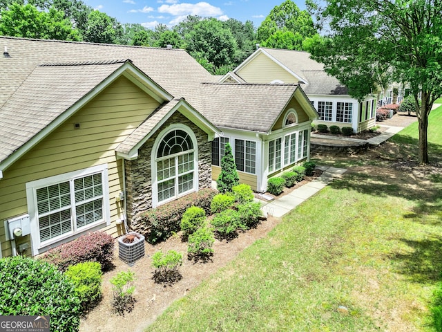 140 Rehobeth Way, Fayetteville, GA 30214 - rear view of property featuring roof with shingles, stone siding, and a yard