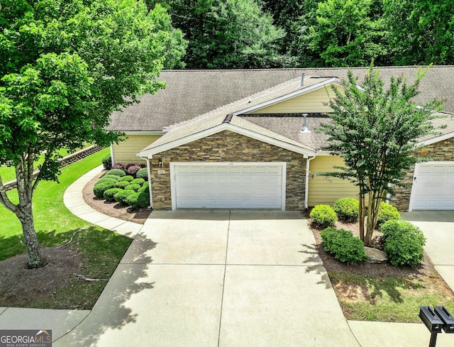 140 Rehobeth Way, Fayetteville, GA 30214 - view of front of house featuring stone siding, concrete driveway, roof with shingles, and an attached garage