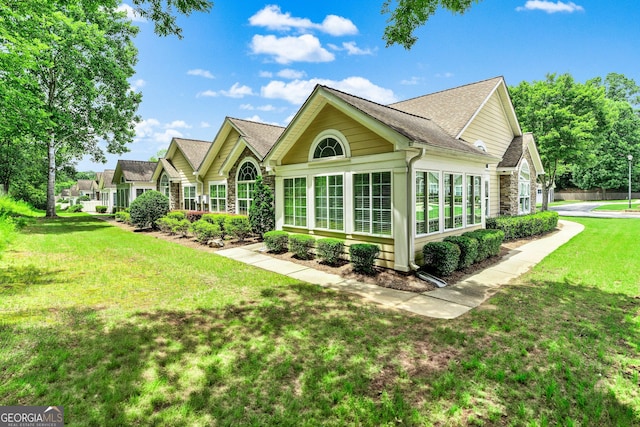 140 Rehobeth Way, Fayetteville, GA 30214 - back of house with stone siding, a yard, and a shingled roof