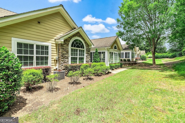 140 Rehobeth Way, Fayetteville, GA 30214 - rear view of property with a lawn, roof with shingles, and stone siding