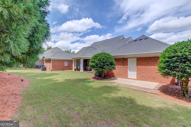 3468 Aberrone Pl, Buford, GA 30519 - rear view of house with brick siding, a lawn, and a patio