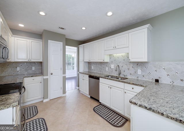 35 Deep Springs Way, Covington, GA 30016 - kitchen featuring appliances with stainless steel finishes, a sink, white cabinetry, and recessed lighting