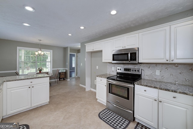 35 Deep Springs Way, Covington, GA 30016 - kitchen featuring stainless steel appliances, a chandelier, white cabinetry, decorative backsplash, and recessed lighting