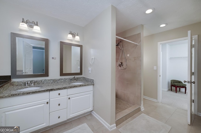 35 Deep Springs Way, Covington, GA 30016 - full bath featuring double vanity, tiled shower, tile patterned flooring, baseboards, and recessed lighting