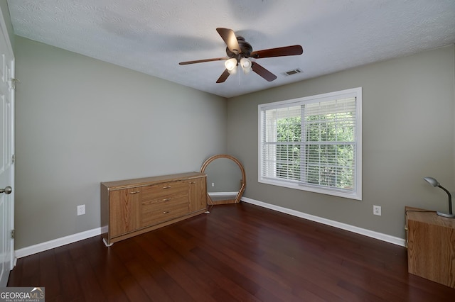 35 Deep Springs Way, Covington, GA 30016 - unfurnished bedroom with dark wood-type flooring, baseboards, a ceiling fan, and a textured ceiling