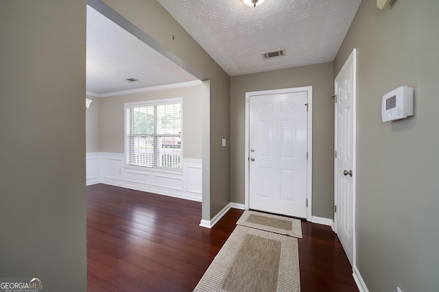 35 Deep Springs Way, Covington, GA 30016 - foyer entrance with wood finished floors, crown molding, a textured ceiling, a wainscoted wall, and baseboards