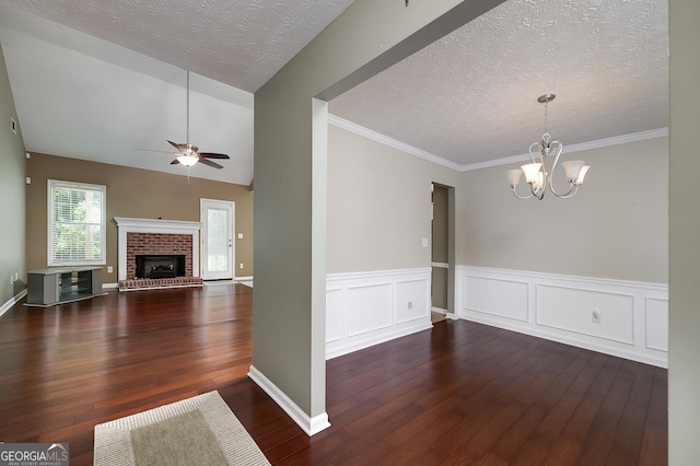 35 Deep Springs Way, Covington, GA 30016 - unfurnished dining area with wood finished floors, ceiling fan, a chandelier, a textured ceiling, and a brick fireplace