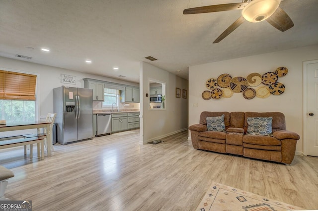 527 Malcom Rd, Covington, GA 30014 - living area with light wood-style flooring, a ceiling fan, baseboards, and recessed lighting