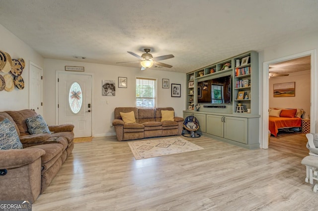 527 Malcom Rd, Covington, GA 30014 - living area with ceiling fan, light wood-type flooring, and a textured ceiling