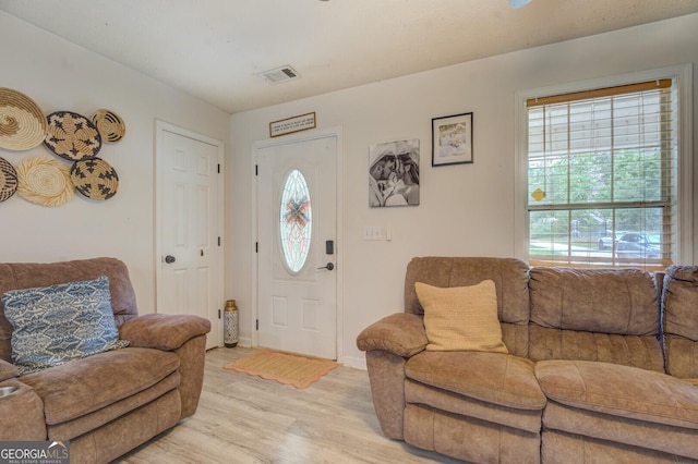 527 Malcom Rd, Covington, GA 30014 - living room featuring plenty of natural light, light wood-style floors, and baseboards