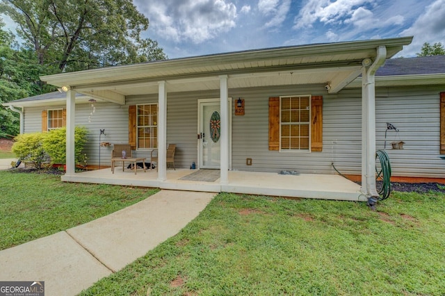 527 Malcom Rd, Covington, GA 30014 - view of front facade with a front lawn and a porch