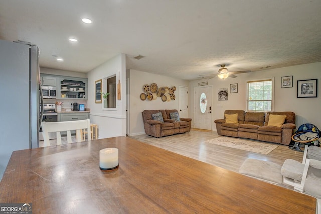 527 Malcom Rd, Covington, GA 30014 - living room featuring light wood-style floors, a ceiling fan, and recessed lighting