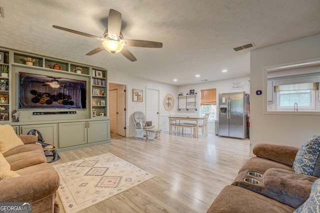 527 Malcom Rd, Covington, GA 30014 - living room featuring light wood-type flooring, ceiling fan, a textured ceiling, and recessed lighting