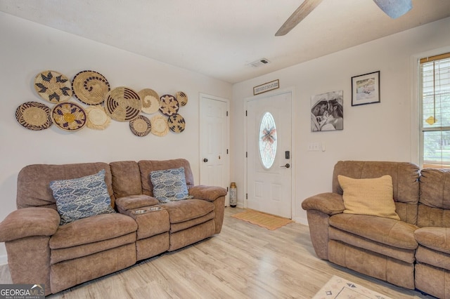 527 Malcom Rd, Covington, GA 30014 - living room with light wood finished floors, a ceiling fan, and baseboards