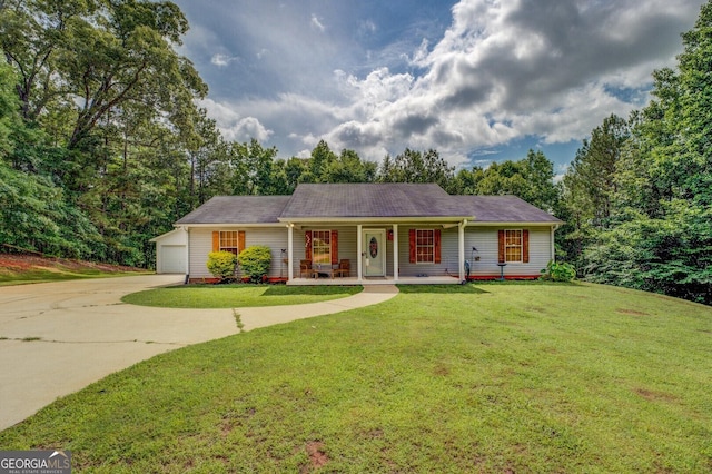 527 Malcom Rd, Covington, GA 30014 - single story home with a porch, concrete driveway, and a front lawn