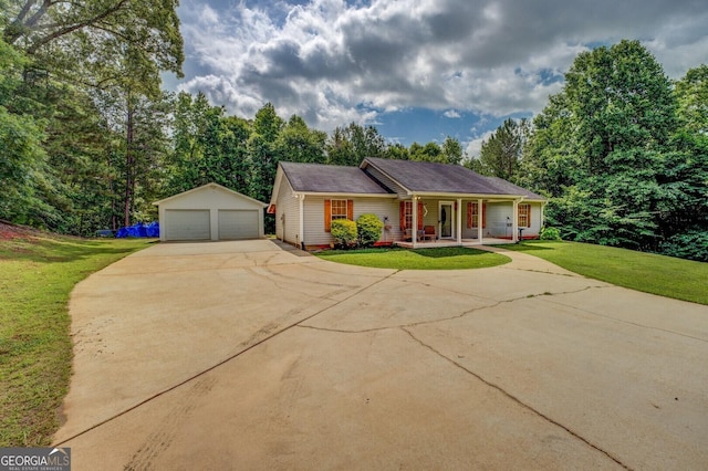 527 Malcom Rd, Covington, GA 30014 - view of front of home featuring covered porch, a garage, a front lawn, and an outdoor structure