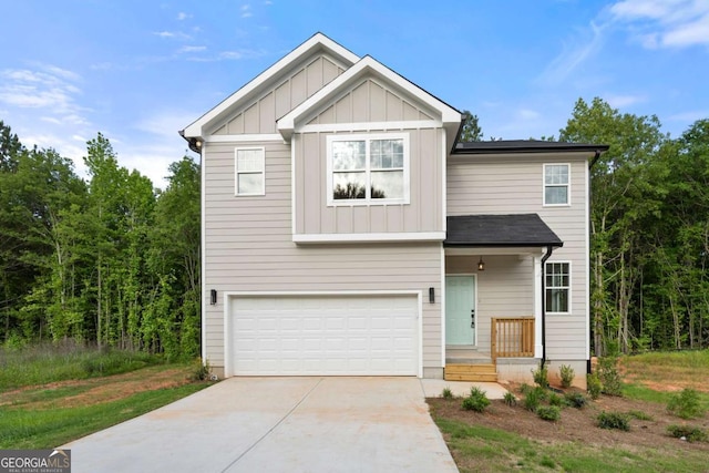 4095 Oriole Ln, Fairburn, GA 30213 - view of front facade with board and batten siding, driveway, and a garage
