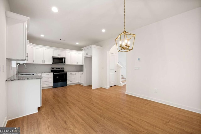 4095 Oriole Ln, Fairburn, GA 30213 - kitchen featuring range with electric cooktop, stainless steel microwave, stone countertops, recessed lighting, and white cabinetry