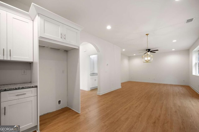 4095 Oriole Ln, Fairburn, GA 30213 - kitchen featuring arched walkways, a ceiling fan, white cabinets, light wood-style flooring, and recessed lighting