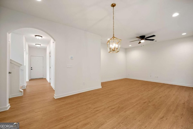 4095 Oriole Ln, Fairburn, GA 30213 - spare room featuring arched walkways, recessed lighting, light wood-type flooring, ceiling fan, and stairway