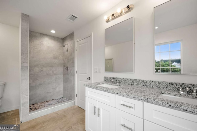 4095 Oriole Ln, Fairburn, GA 30213 - bathroom featuring a tile shower, double vanity, recessed lighting, and tile patterned flooring