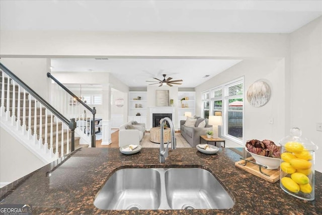 3607 Archgate Ct, Alpharetta, GA 30004 - kitchen featuring built in features, ceiling fan, dark stone counters, and a fireplace