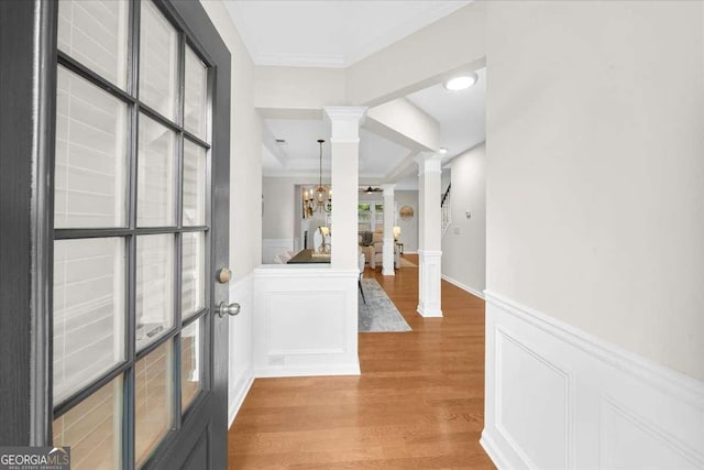 3607 Archgate Ct, Alpharetta, GA 30004 - entrance foyer with decorative columns, light wood-type flooring, a wainscoted wall, crown molding, and a chandelier