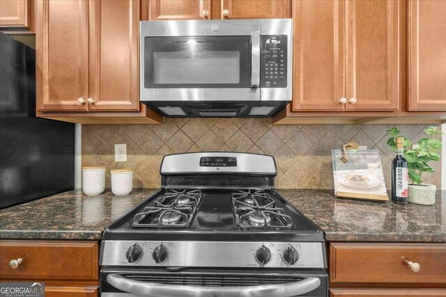 3607 Archgate Ct, Alpharetta, GA 30004 - kitchen featuring appliances with stainless steel finishes, brown cabinets, backsplash, and dark stone counters